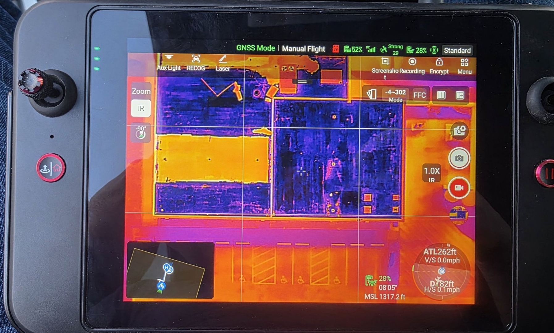 Thermal imaging drone controller showing roof moisture scan